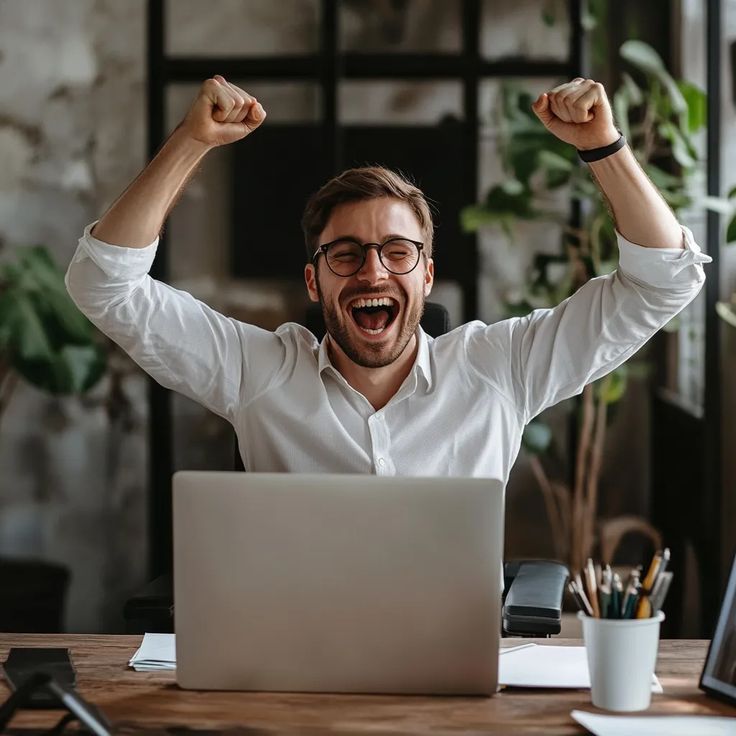 Excited business owner celebrating remote team success at laptop